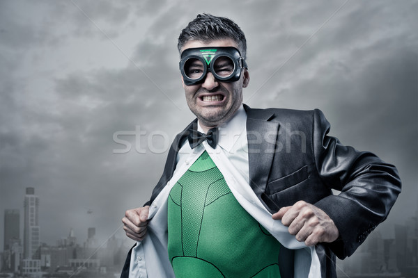 Superhero taking off shirt and jacket Stock photo © stokkete