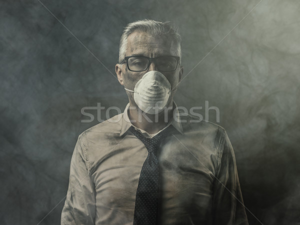 Businessman with mask and air pollution Stock photo © stokkete