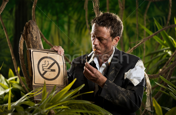 Businessman smoking in the jungle Stock photo © stokkete