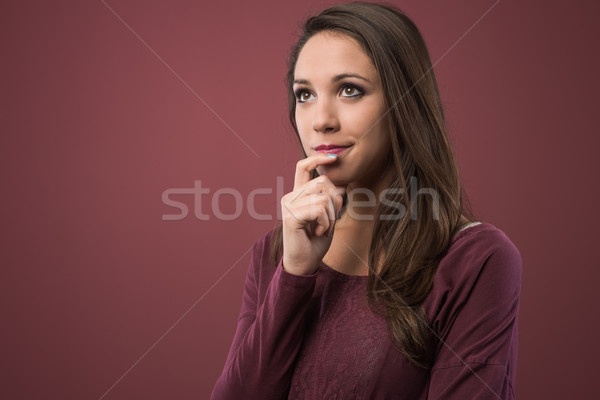 Pensive woman with hand on chin Stock photo © stokkete