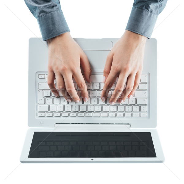 Blogger typing on a laptop Stock photo © stokkete