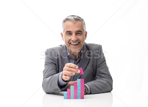 Businessman building a staircase with wood blocks Stock photo © stokkete