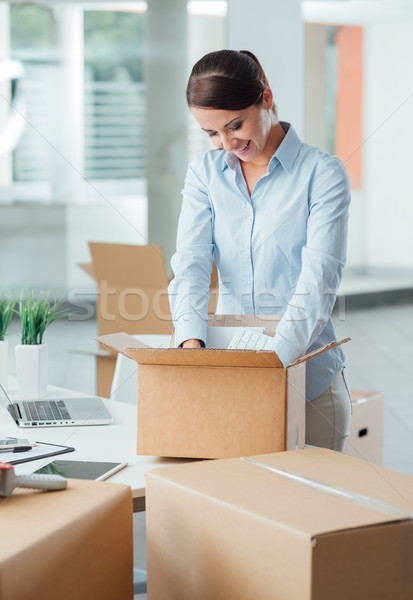 Business woman unpacking in her new office Stock photo © stokkete