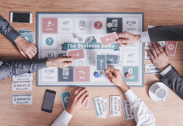 Stock photo: Business people playing a board game