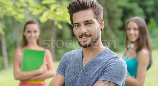 Stock photo: Smiling student posing at the park