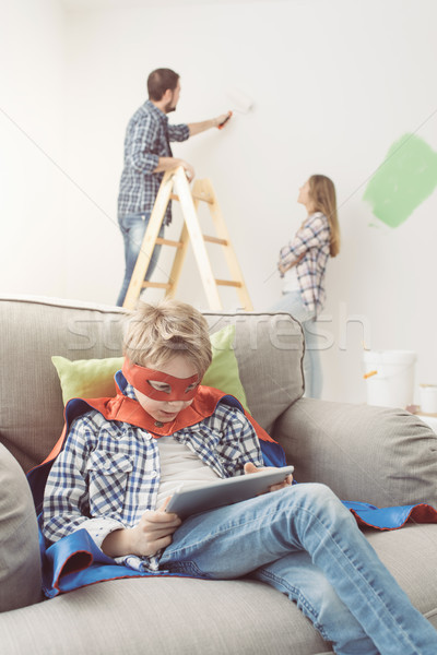 Superhero using a tablet and home makeover Stock photo © stokkete