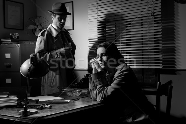 Stock photo: Detective interviewing a young pensive woman in his office