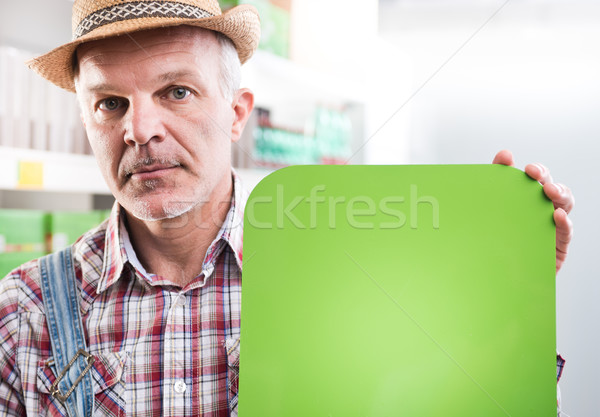 Farmer with sign at supermarket Stock photo © stokkete
