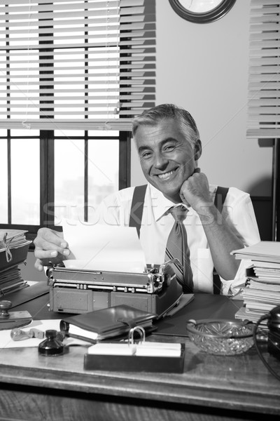 Sorridente retro repórter trabalhando mesa de escritório vintage Foto stock © stokkete
