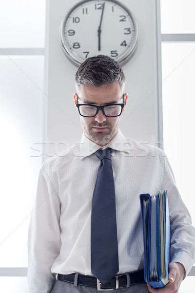 Frustrated businessman standing under a clock Stock photo © stokkete