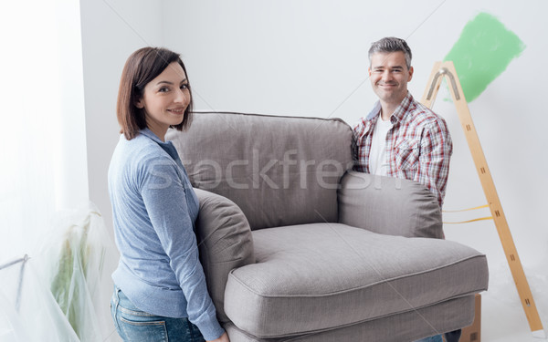 Stock photo: Couple moving furniture in their new house