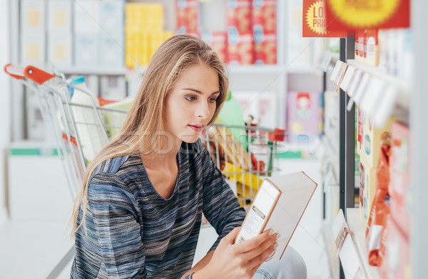 Woman reading food labels Stock photo © stokkete