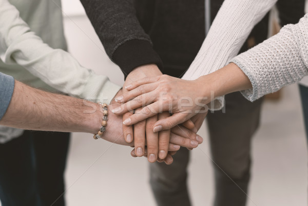 Young people stacking hands Stock photo © stokkete