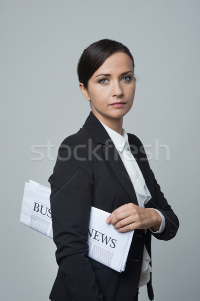Businesswoman with financial newspaper Stock photo © stokkete