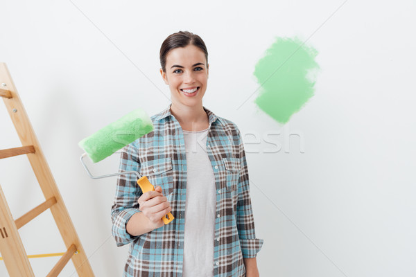 Young woman painting her house Stock photo © stokkete