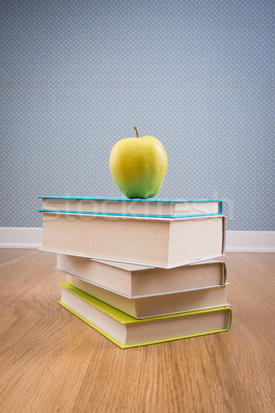 Textbook with yellow apple Stock photo © stokkete