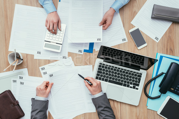 Business people checking tax forms Stock photo © stokkete