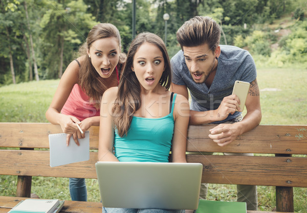 Shocked teenagers using a laptop Stock photo © stokkete