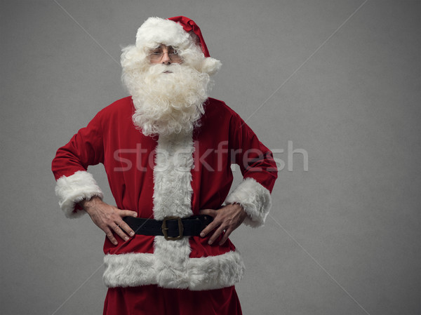 Confident proud Santa posing with arms akimbo Stock photo © stokkete