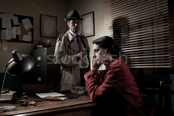 Detective interviewing a young pensive woman in his office Stock photo © stokkete