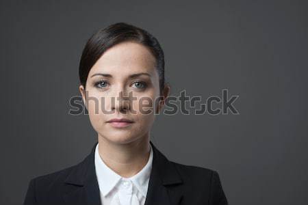 Serious businesswoman staring at camera Stock photo © stokkete