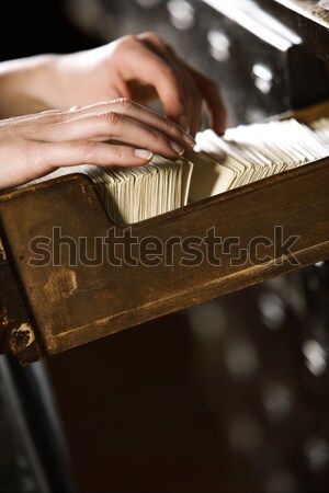Searching in archives. Student hands searching from a filling ca Stock photo © stokkete