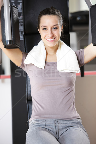 Young woman works out on weight-training machine Stock photo © stokkete