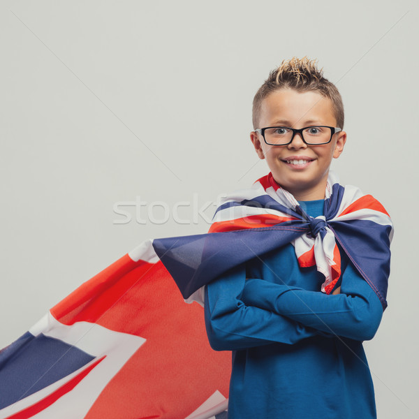 Smiling superhero boy with British flag cape Stock photo © stokkete