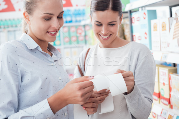 Women comparing their grocery receipts Stock photo © stokkete