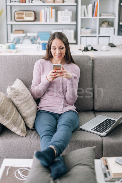 Woman texting with her smartphone Stock photo © stokkete