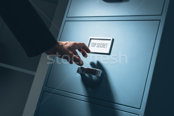 Office worker searching confidential information Stock photo © stokkete