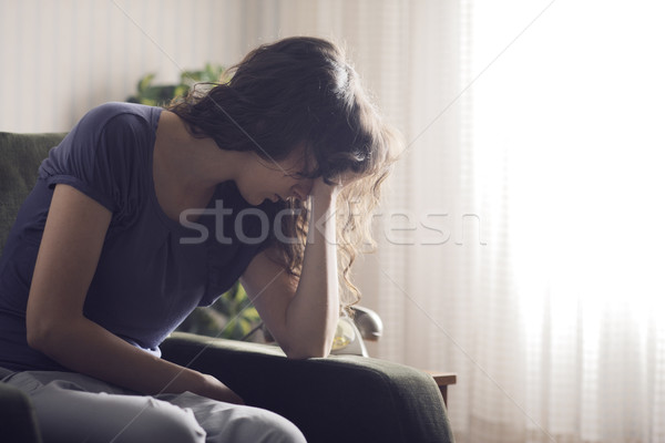 Magány lehangolt fiatal nő ül szék otthon Stock fotó © stokkete