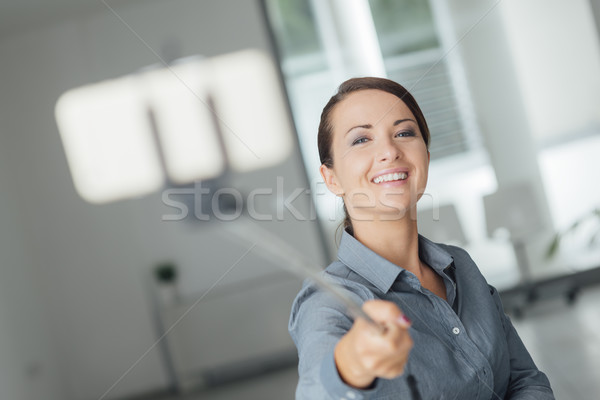 Woman taking a self portrait using a selfie stick Stock photo © stokkete