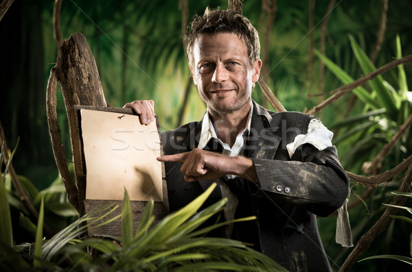 Niedobitek biznesmen wskazując podpisania uśmiechnięty dżungli Zdjęcia stock © stokkete