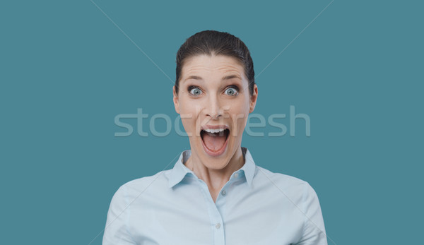 Surprised happy woman looking at camera Stock photo © stokkete