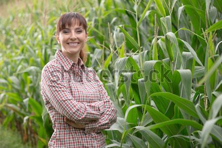 Smiling farmer posing in the corn field Stock photo © stokkete