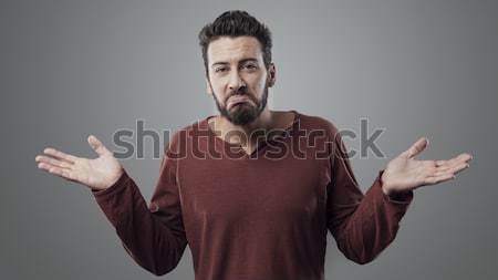 Young man shrugging Stock photo © stokkete