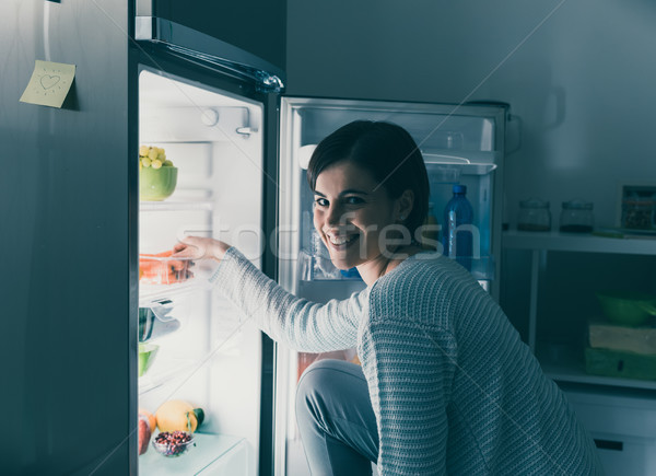 Woman taking food out of the fridge Stock photo © stokkete