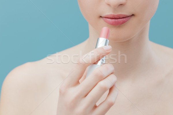 Woman applying lipstick Stock photo © stokkete
