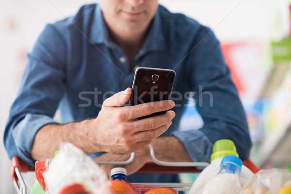 Stock photo: Man shopping and using mobile apps