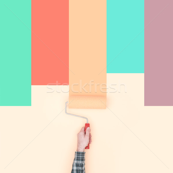 Stock photo: Decorator painting colorful stripes on a wall