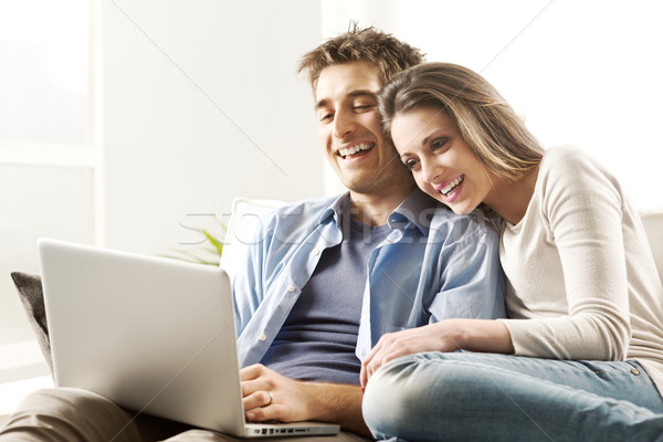 Couple relaxing on sofa with laptop Stock photo © stokkete