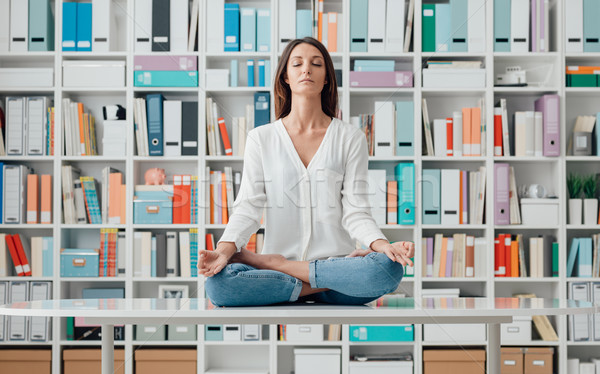 Woman practicing meditation on a desk Stock photo © stokkete