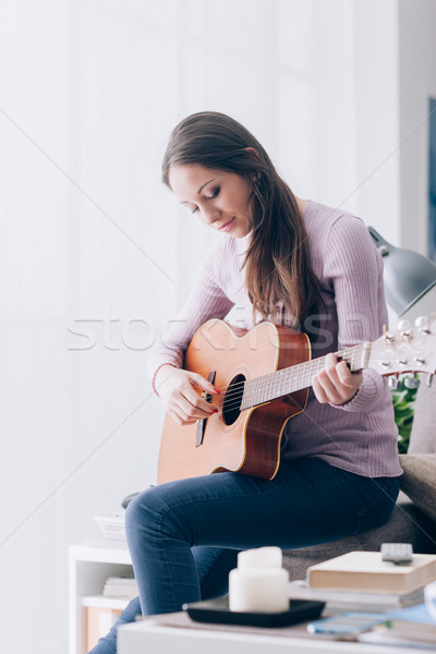 Stock photo: Girl playing guitar at home