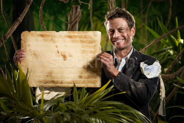 Stock photo: Businessman with old paper parchment in the jungle