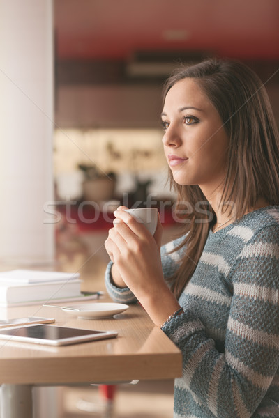 Stock photo: Pretty girl having a coffee at the bar