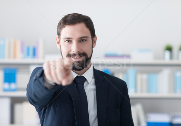 Smiling businessman pointing at camera Stock photo © stokkete