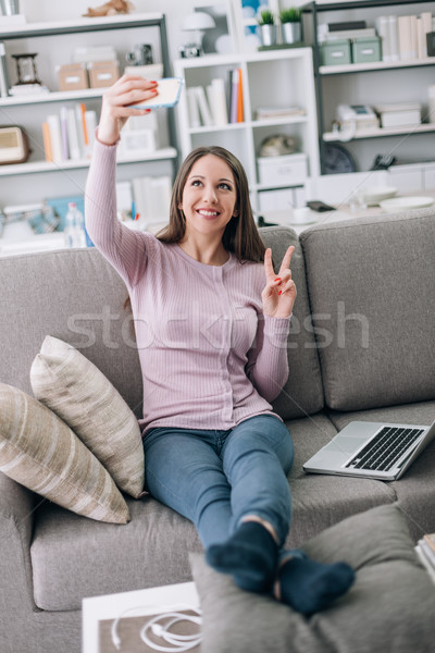 Cute girl using a smartphone Stock photo © stokkete