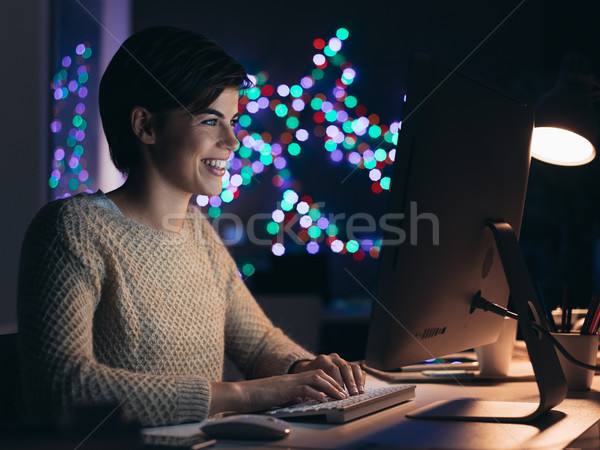 Happy woman connecting late at night Stock photo © stokkete