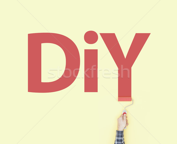 Stock photo: Decorator painting DIY on a wall